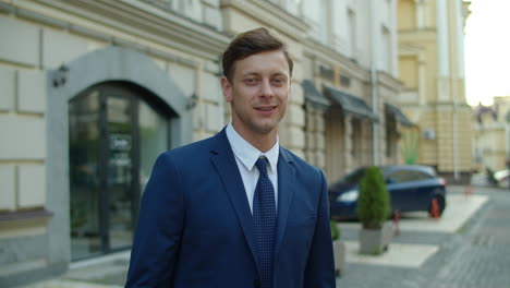 confident business man looking at camera outdoors