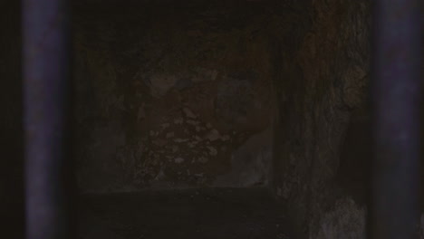 A castle jail view with the bars and lock.