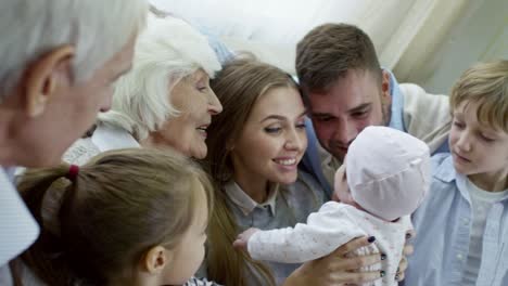 extended family playing with baby