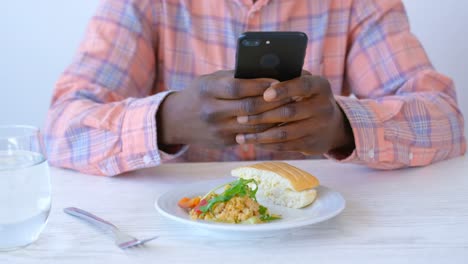 african-american male executive using mobile phone in modern office 4k