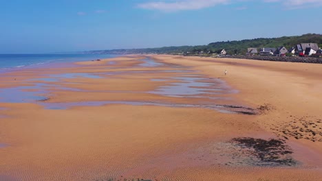 Good-aerial-over-man-running-Omaha-Beach-Normandy-France-site-of-World-War-two-D-Day-allied-invasion