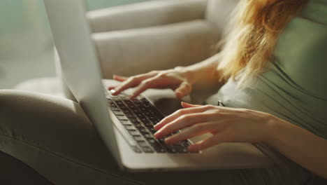 woman typing on laptop keyboard