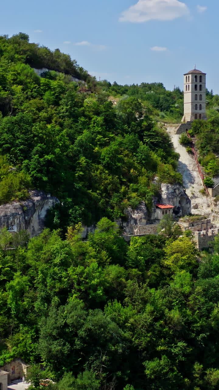 Aerial view of mountain monastery. Antique and heritage stronghold fortification on rock. Vertical video