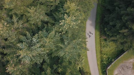 Young-couple-together-walk-in-the-park.-Summer-weather.-Shooting-from-the-air