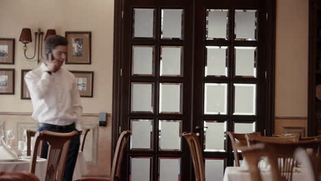man talking on phone in a restaurant