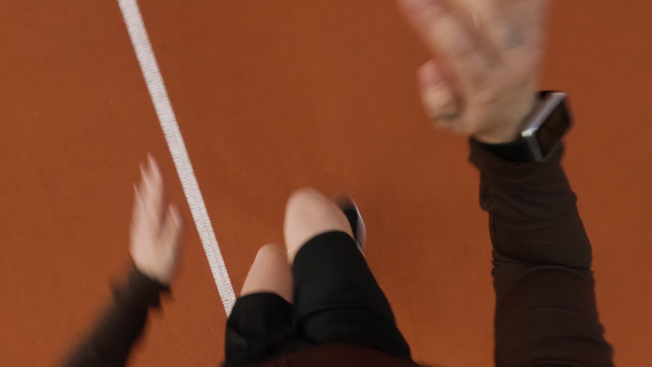 First-person view of a person running on an athletic track