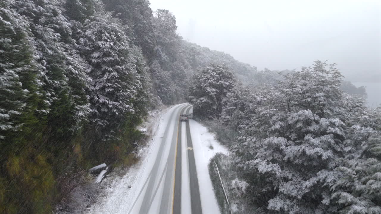 Aerial view of car traveling on a snow-covered road, Route 40 highway, Bariloche Patagonia Argentina