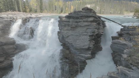 breathtaking waterfall cascading through rocky landscape in a natural forest environment