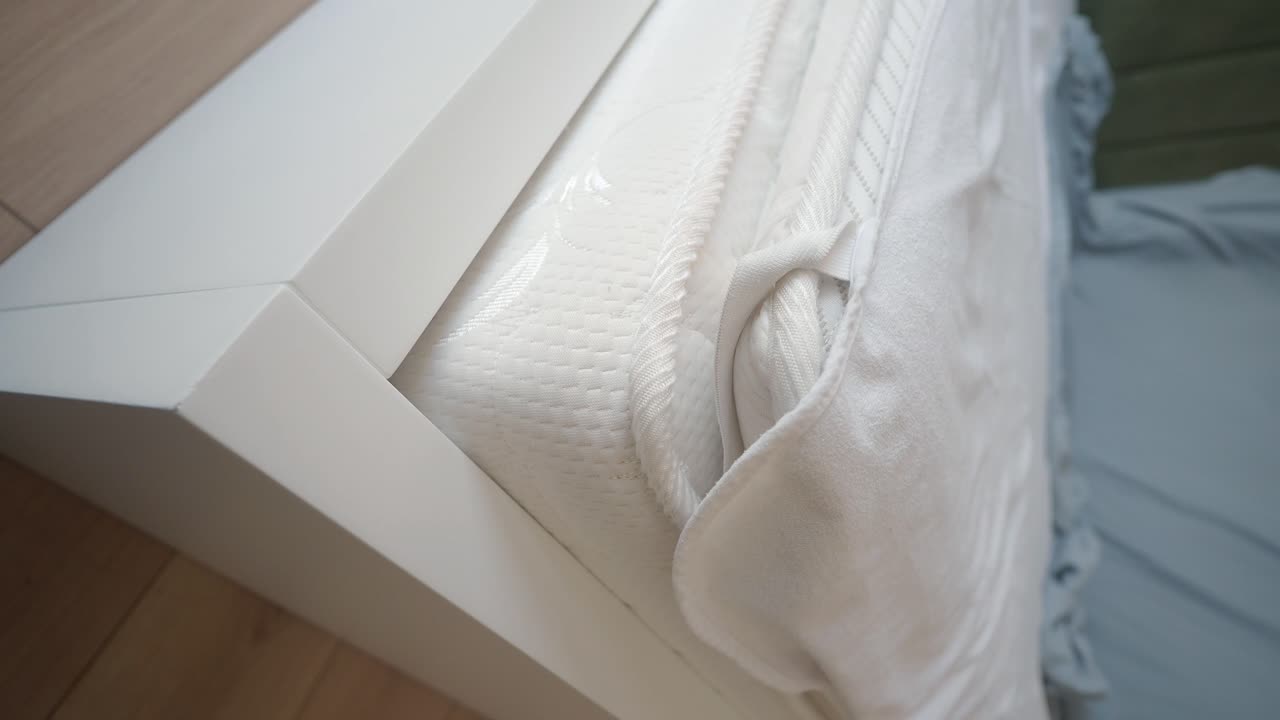 White Bed Frame and Mattress Close-up
