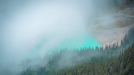 time lapse, moving fog above aqua blue glacial water in high elevation, lake louise banff national park, canada