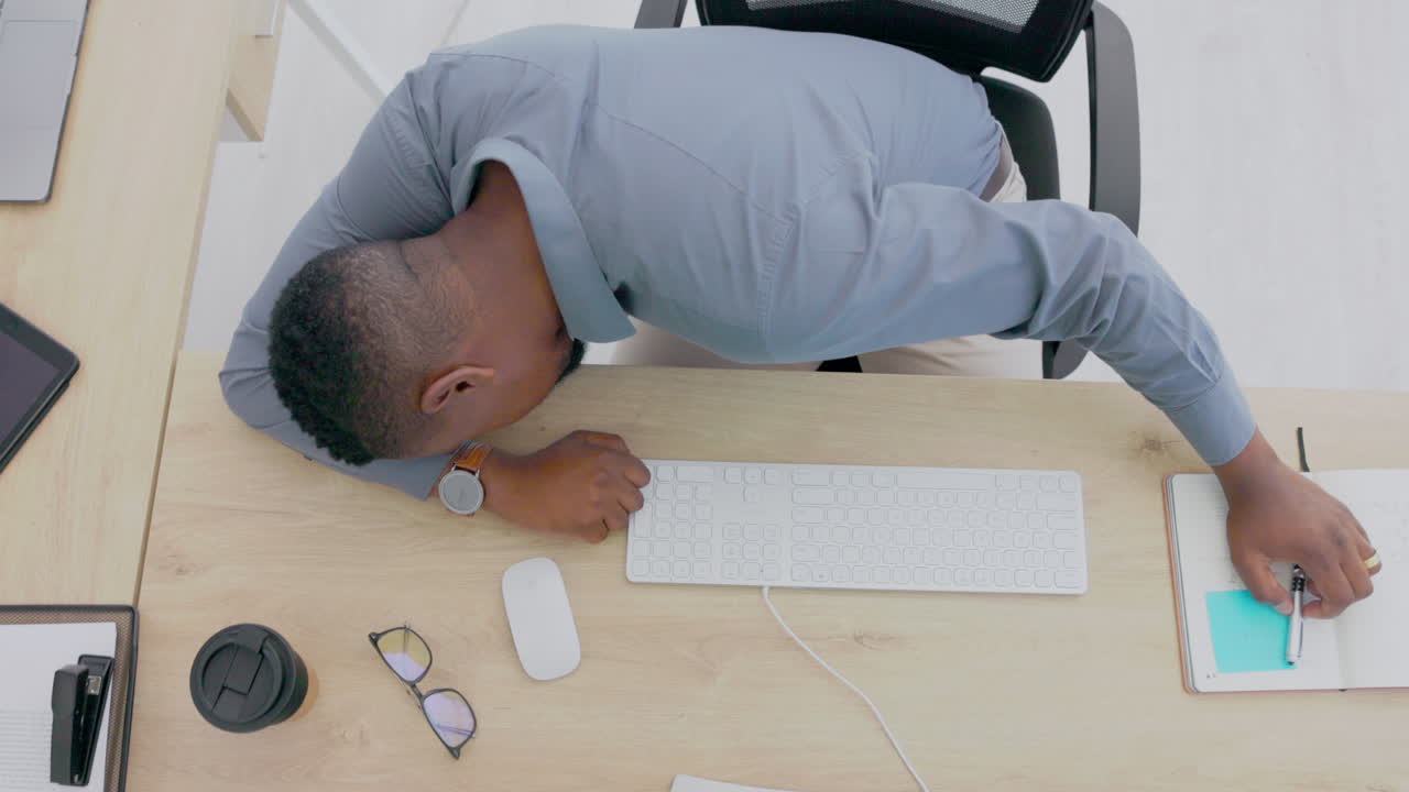 Top view, black man and sleeping at desk