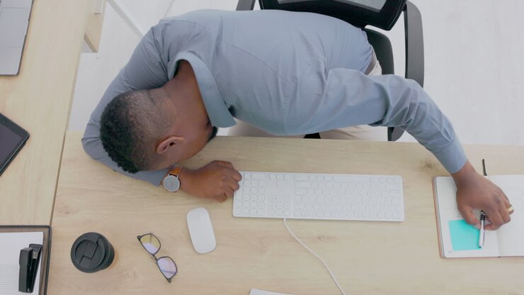Top view, black man and sleeping at desk