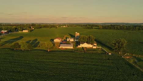 Eine-Luftaufnahme-Von-Amish-Farmen-Und-Feldern-Während-Der-Goldenen-Stunde-An-Einem-Spätsommernachmittag