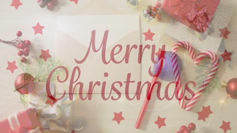 animation of christmas greetings text over envelope, christmas presents and decorations