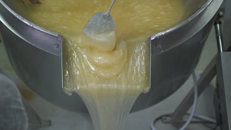 a factory making turkish delight as the hot sticky base is poured out of a large vat