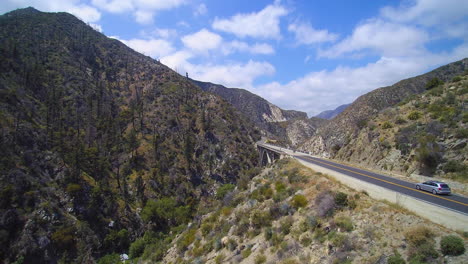 drone shot of cars traveling towards big tujunga narrows bridge in southern california