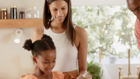 young girl planting herbs in kitchen, enjoying gardening activity with diverse family, at garden