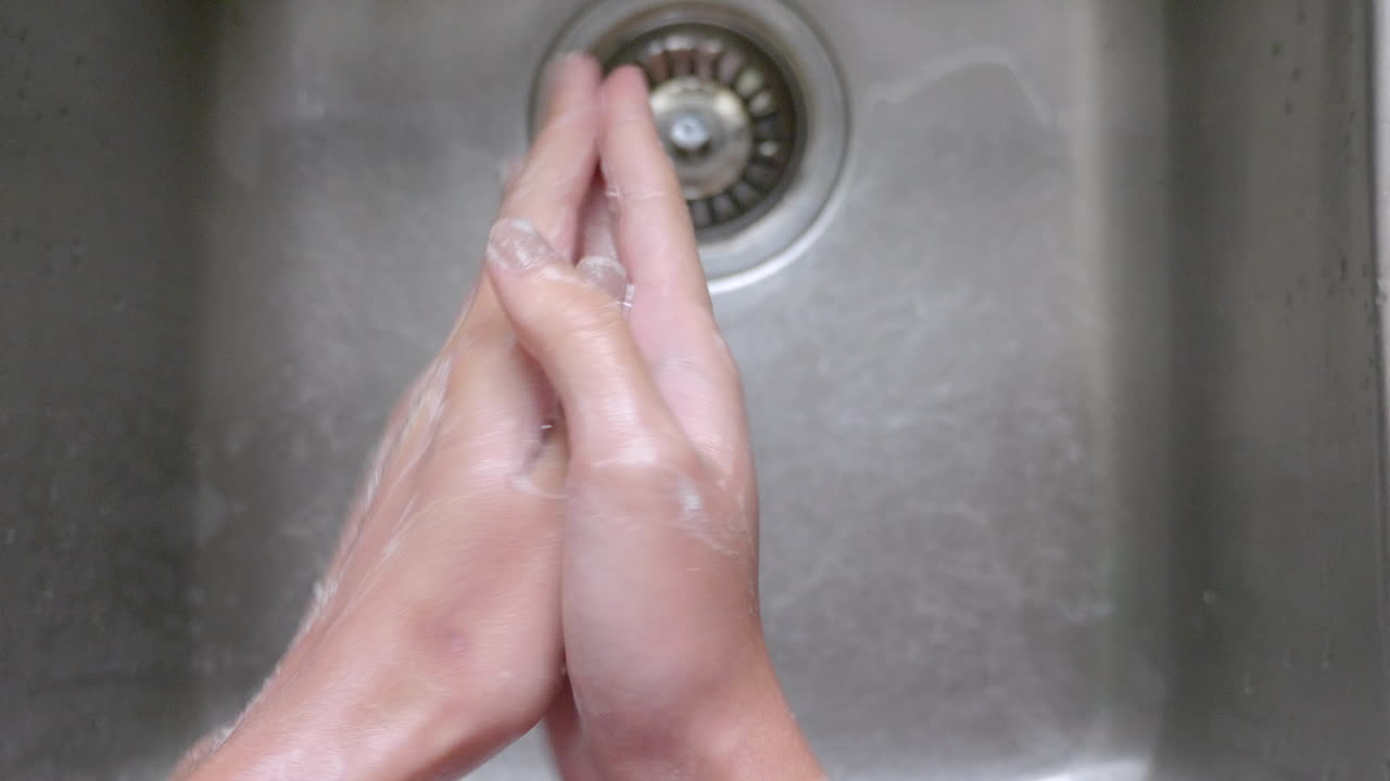 Person Cleaning His Hands With Soap To Prevent Corona Virus - Close Up Shot