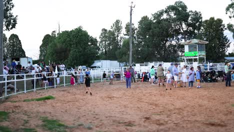 people gathering at a rodeo arena