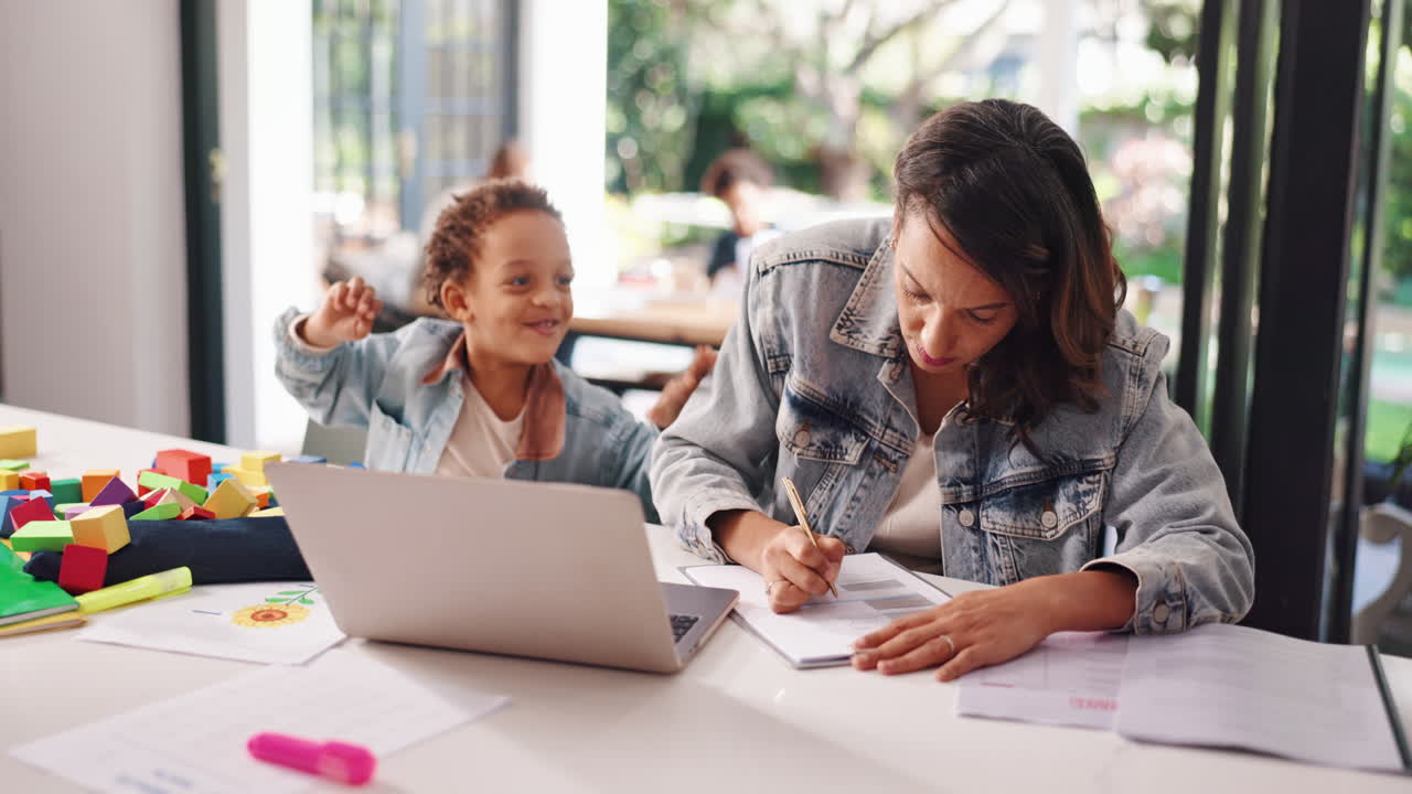 Mother Working from Home While Son Plays