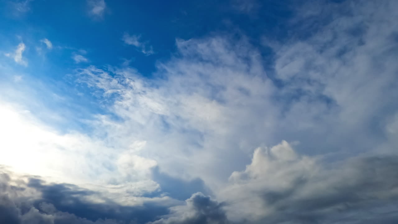 Grey clouds quickly covering the sky. Low angle view at the dramatic cloudscape blown by the wind. Timelapse