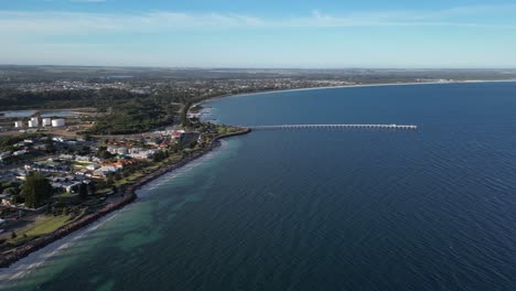 Long-jetty-from-seaside-of-Esperance-Town-in-Western-Australia,-aerial-dynamic-wide