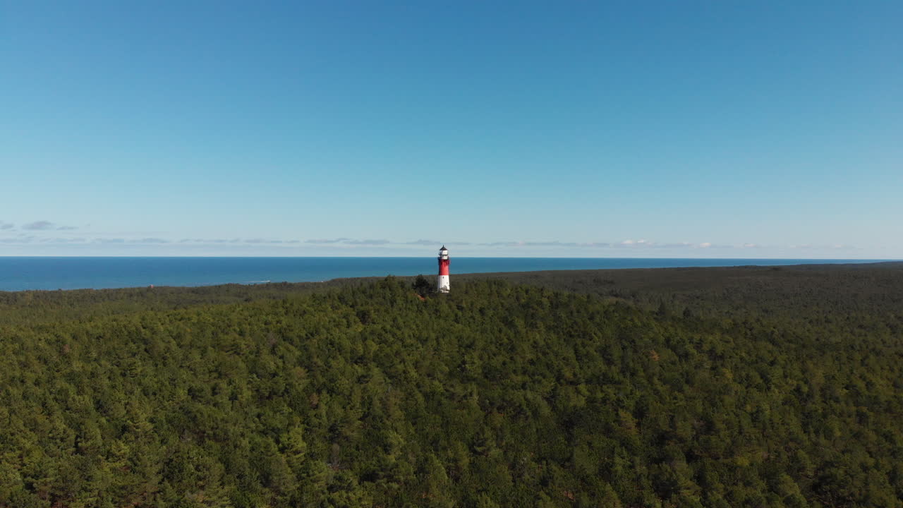 Red and white lighthouse in the forest