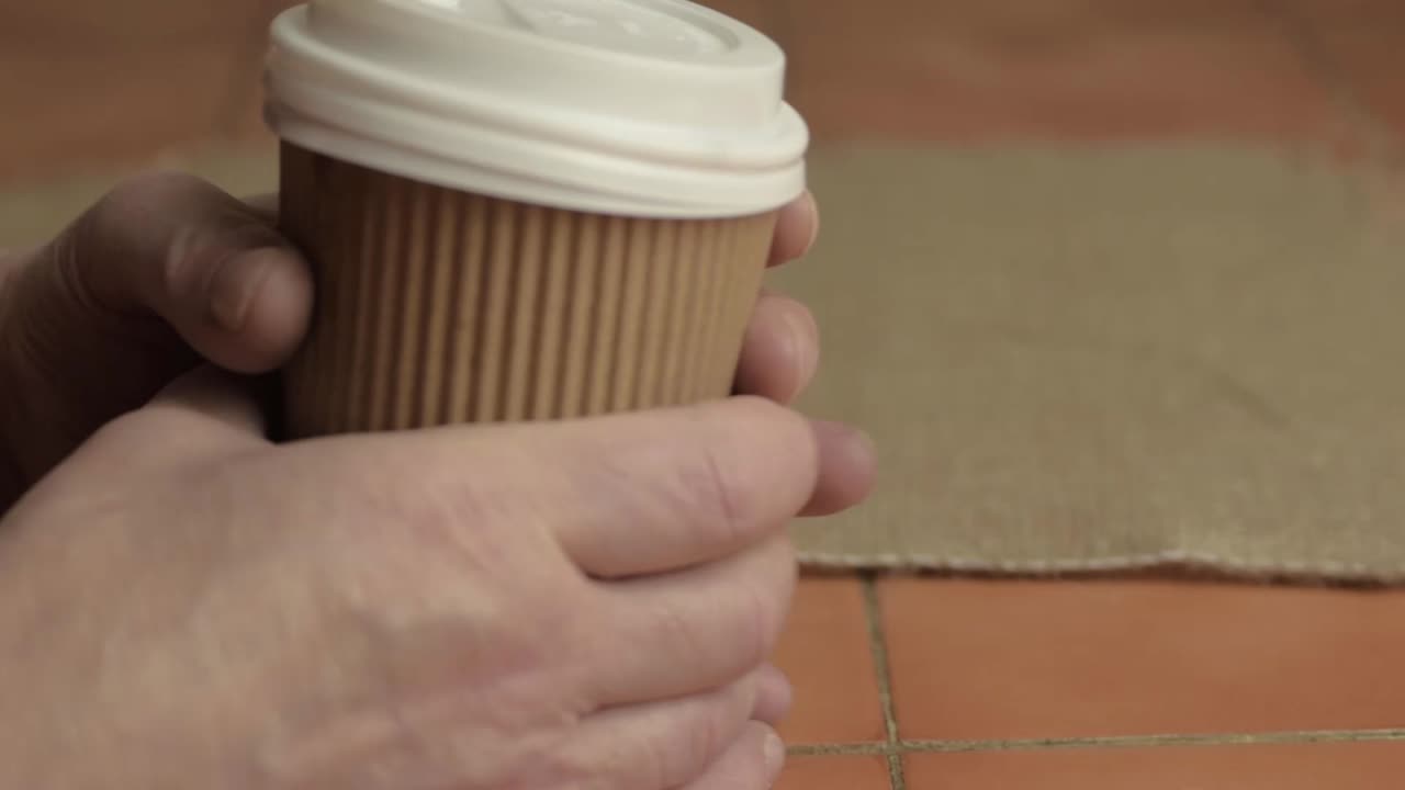 Hands removes lid of takeaway coffee to-go close up