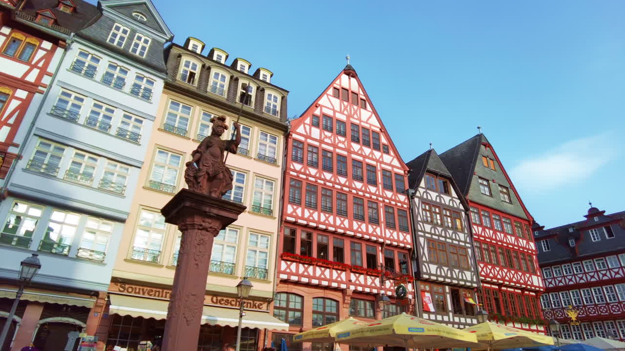 View of the Roemerberg in Frankfurt, Germany. Square with Old St. Nicholas Church, a column and half-timbered buildings