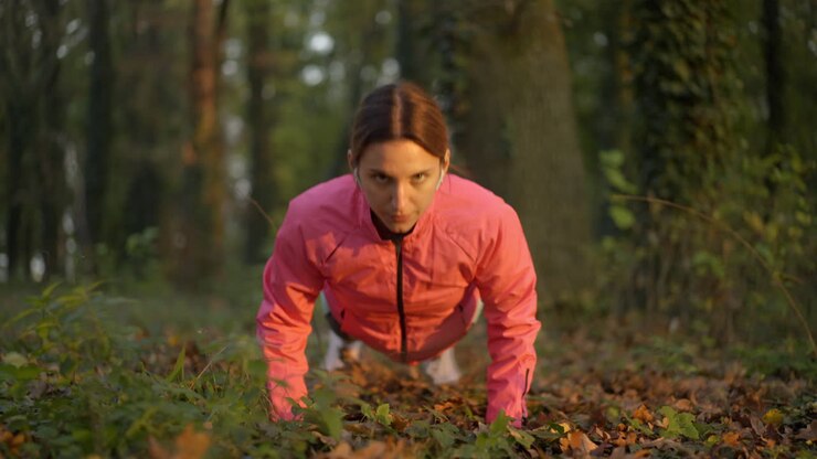 Woman doing push-ups in a park