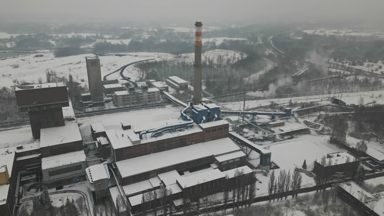 Aerial reveal Karviná industrial coalmine in bleak frozen winter landscape