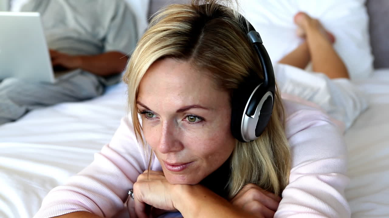 mujer tranquila cerrando los ojos mientras escucha música