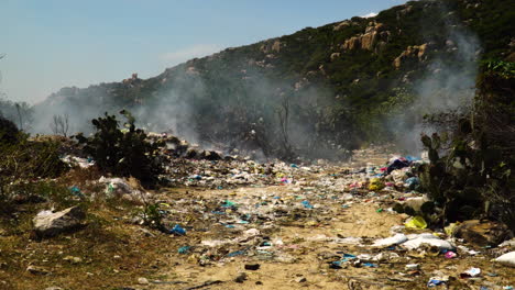 Burning garbage at landfill in Vietnam causing air pollution, global warming concept