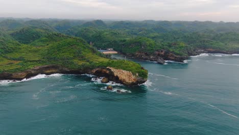 Scenic-aerial-view-on-southern-Java-cliffs-and-Ngrenehan-Beach-hidden-in-a-bay