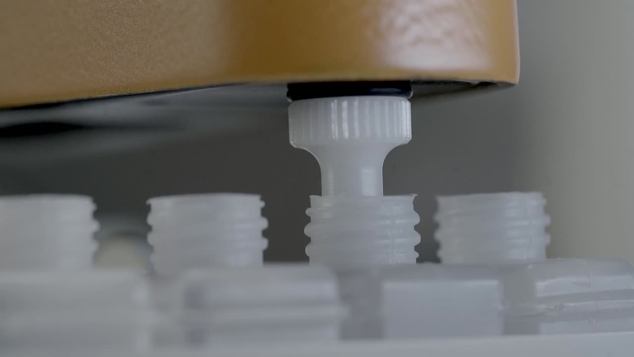 Needle Of Chemistry Analyzer Machine Sucking Reactant Solution On Bottle For Blood Test