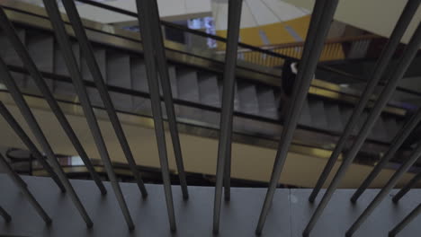 a slow motion of a moving escalator with a man on it