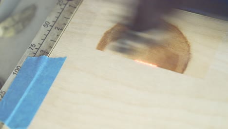 Close-up-view-at-laser-engraving-picture-in-wooden-plank