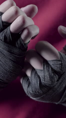 close-up view of hands wrapped in boxing wraps