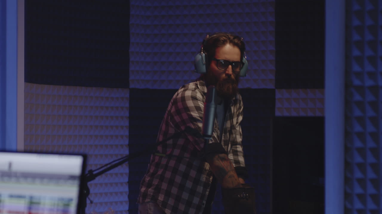 Man in Recording Studio with Microphone and Bubble Wrap