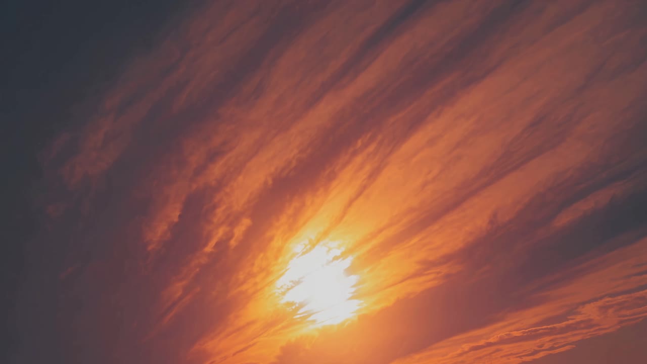 Dramatic sunset video with a low-angle shot capturing vibrant orange and red hues in the sky