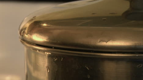 boiling hot water bubbles out of a cooking pot 1