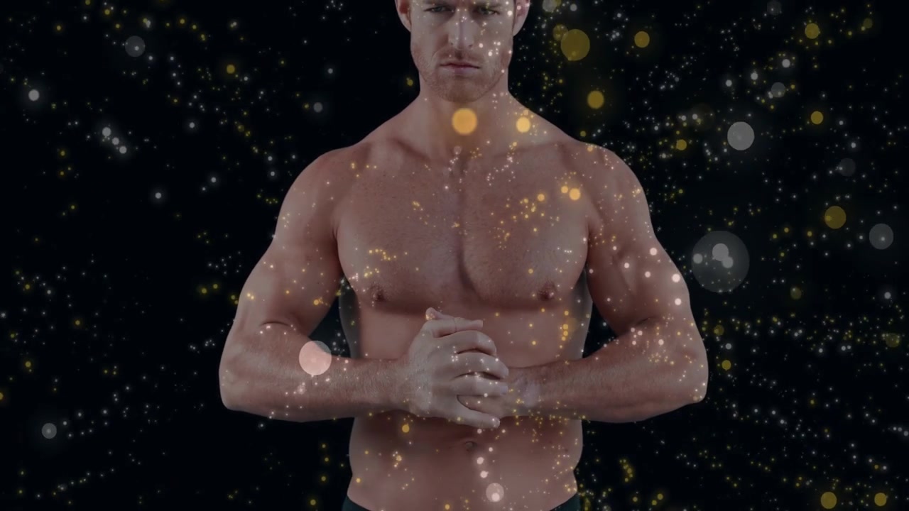 Camera revealing upper body male standing clasping hands particles crossing torso showing fitness