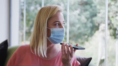 Woman-wearing-face-mask-talking-on-smartphone