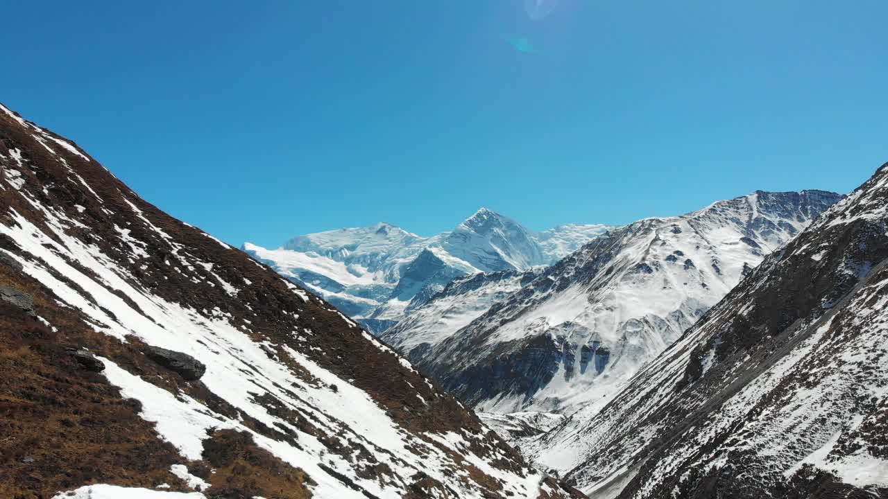 Drone shot revealing Gangapurna and Annapurna three Himalaya mountains in Annapurna Circuit, Manang, Nepal
