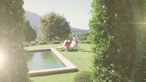 animation of light spots over senior caucasian couple spending time outside