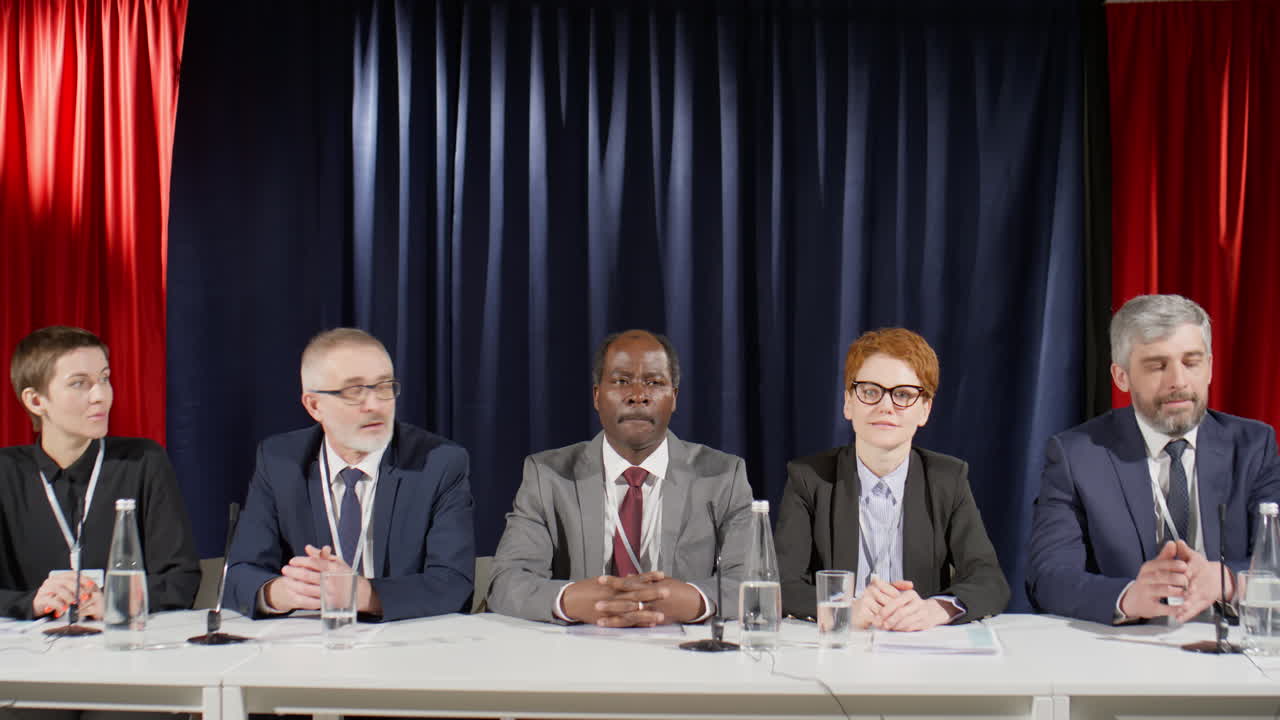 Group of Diverse Political Leaders Speaking at Press Conference