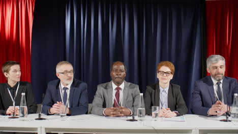 group of diverse political leaders speaking at press conference