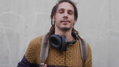 retrato confiado joven de raza mixta estudiante de aspecto serio tranquilo hombre independiente con dreadlocks peinado en cámara lenta