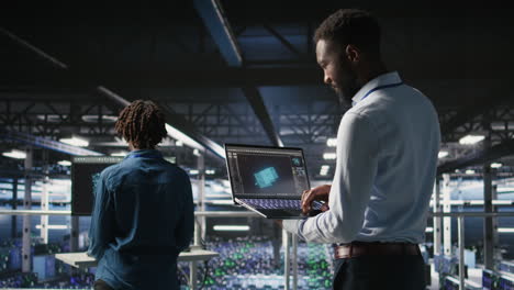 Server hub coworkers visualizing AI large language model using notebook