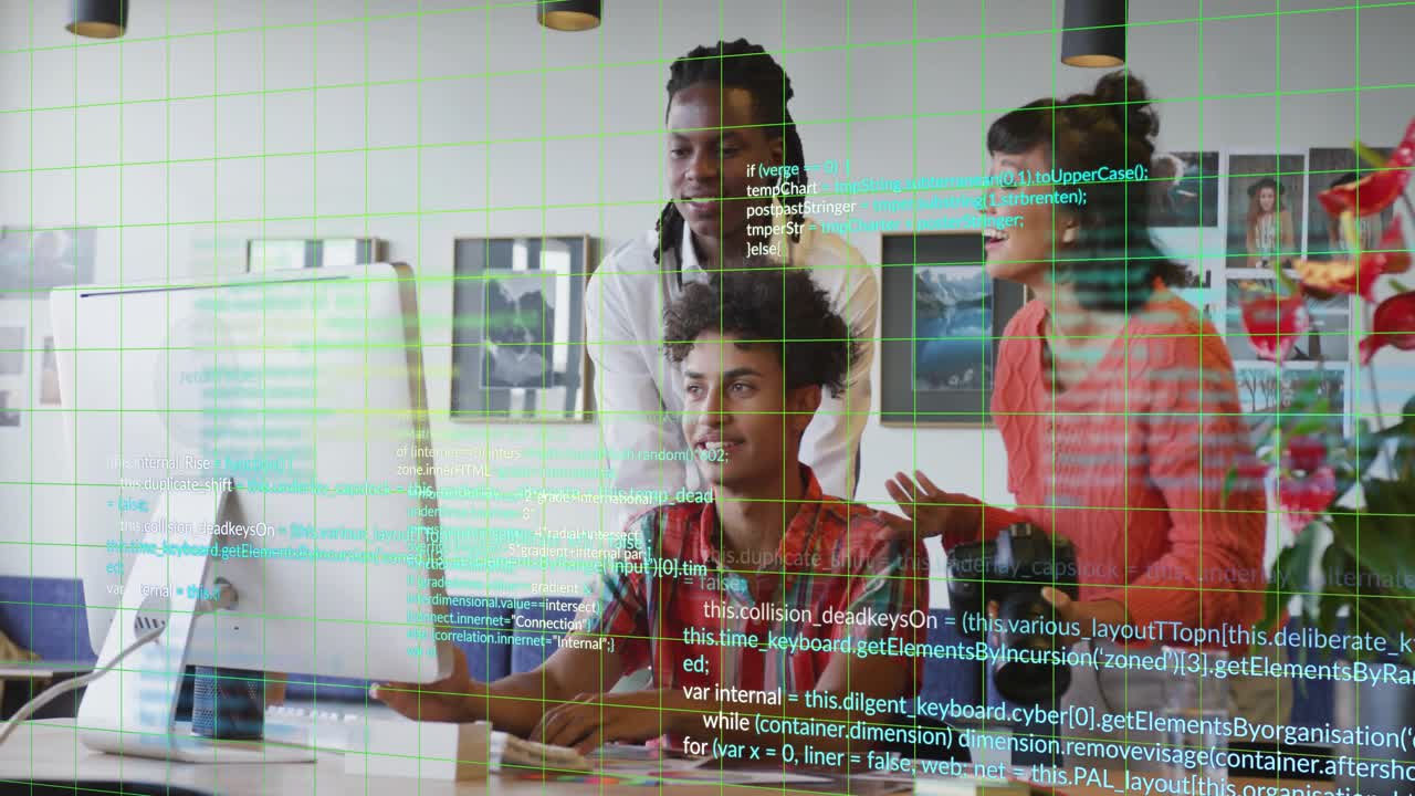 Seated tech dev clicking and typing, starting code overlay while team reviewing monitor design